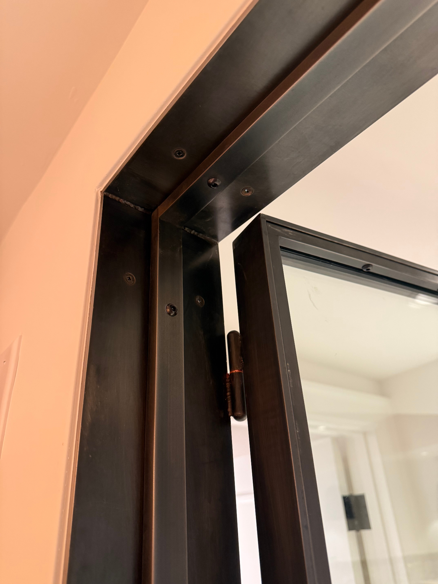 Bronze door frame and hinge detail